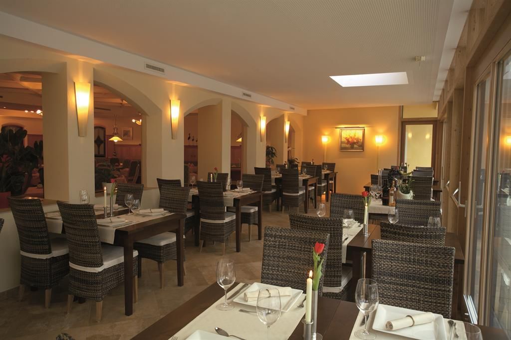 Ein elegantes Restaurant mit stilvollen Tischen und Stühlen. Die Atmosphäre ist warm und einladend.